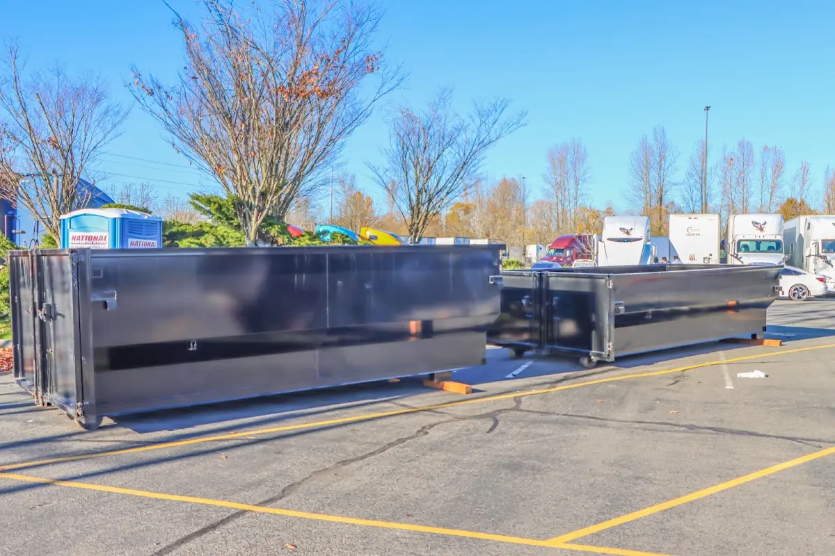 Professional dumpster rental service with roll-off container on residential driveway in Ulster